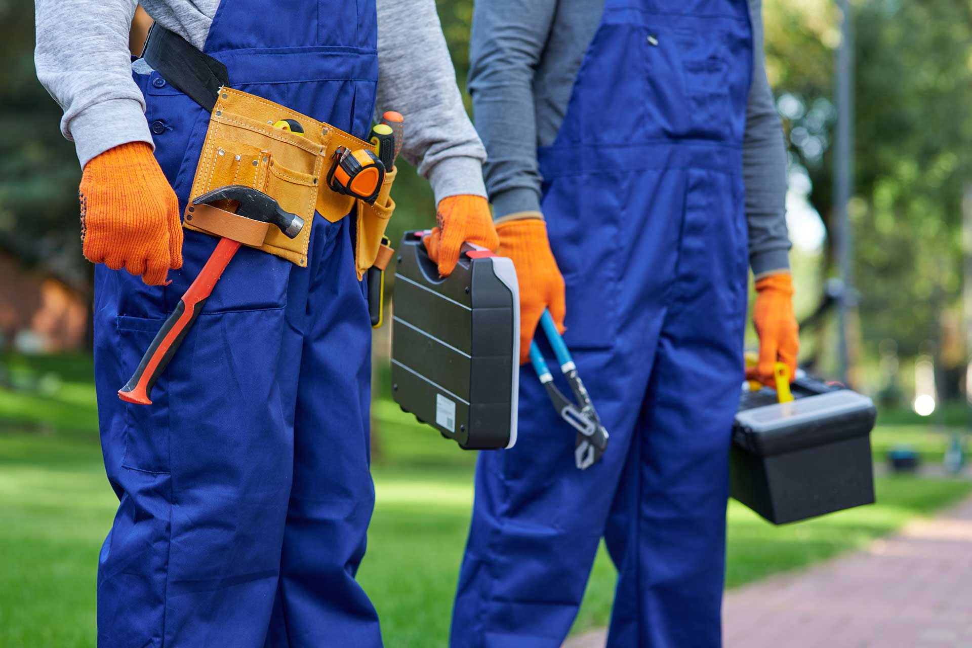 Close-up of workers with tool belts