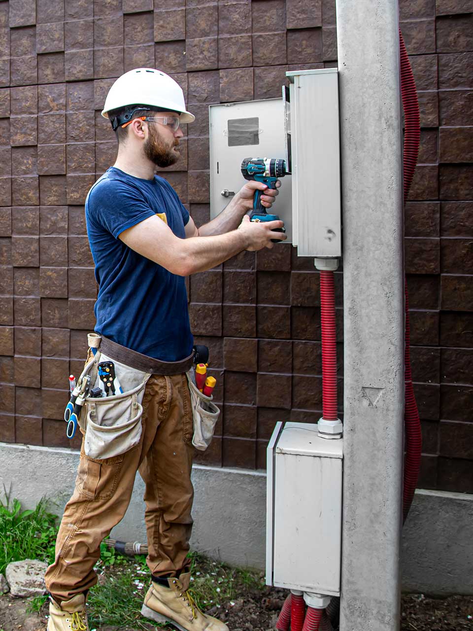 Technician inspecting power panel outdoors