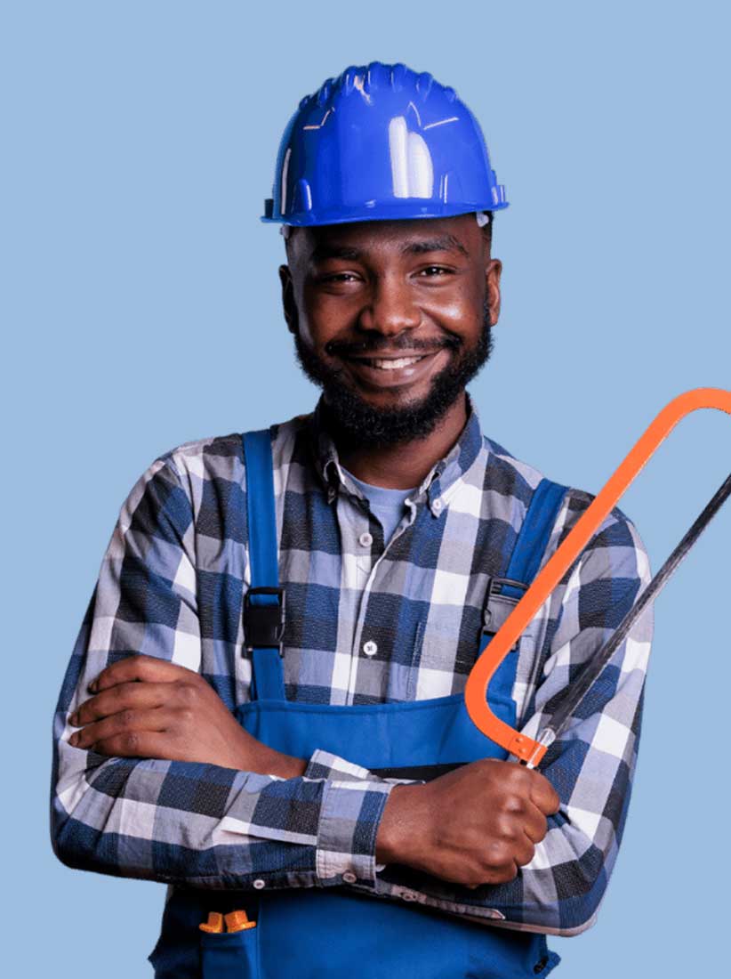 Smiling construction worker holding hacksaw