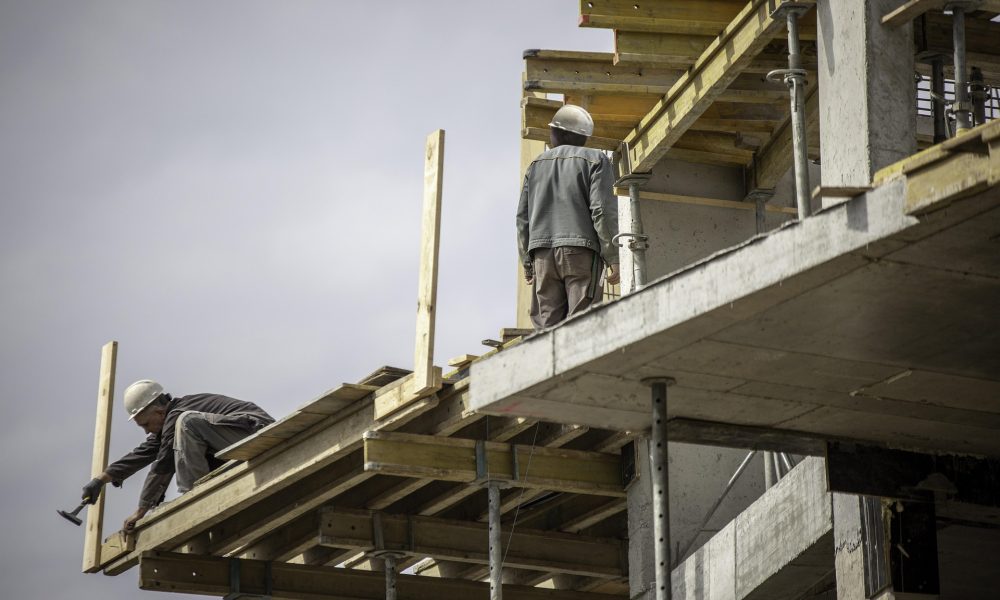 Construction workers on elevated scaffolding